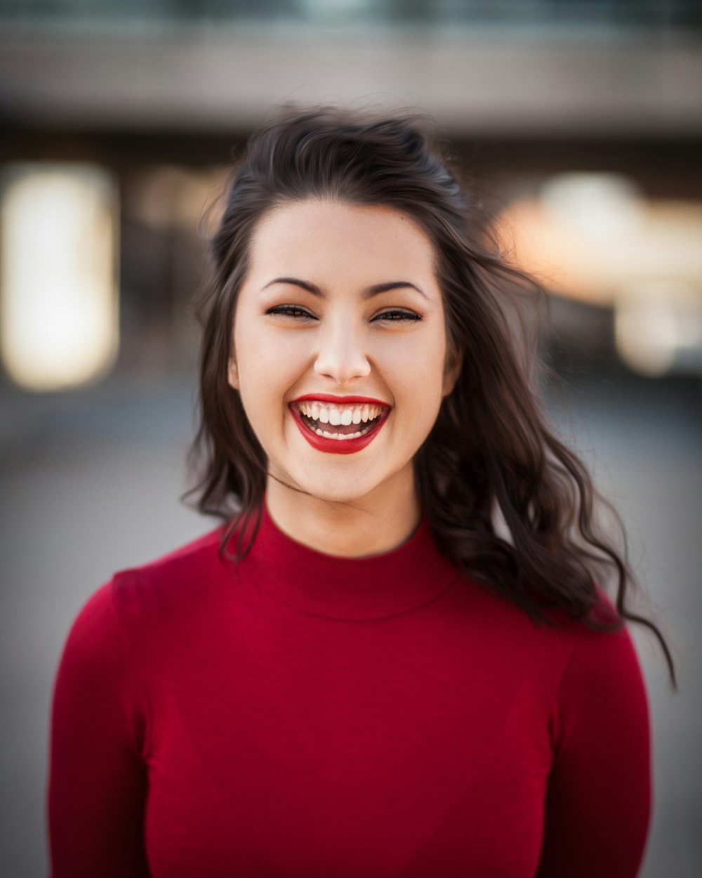 A woman laughing with a wide, healthy smile